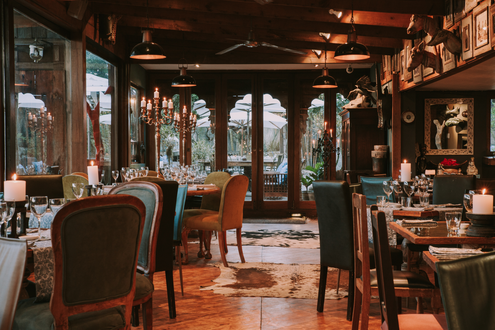 Pierced metal lanterns glowing above a lodge dining area